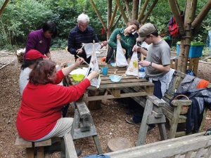 A group of people involved in a community project making mini tipis